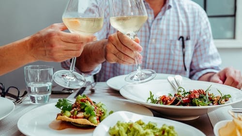 holding wine glasses